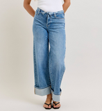 Wide-leg jeans worn by a person on a plain background