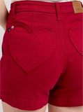 Red denim shorts with heart-shaped pockets on the back